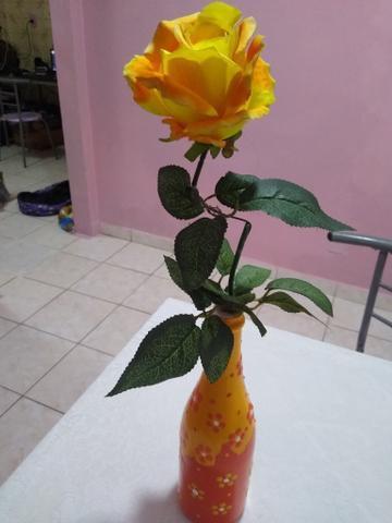 Garrafa decorativa com uma rosa amarela